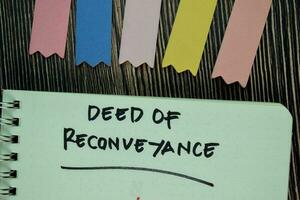 Deed of Reconveyance write on a book isolated on Wooden Table. Business or Financial Concept photo