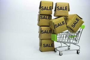 Sale Text in small boxes and shopping cart. Concepts about online shopping. Isolated on white background photo