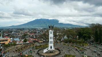 Aerial view of Jam Gadang, a historical and most famous landmark in BukitTinggi City, an icon of the city and the most visited tourist destination by tourists. Bukittinggi, Indonesia, January 25, 2023 photo