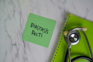 Diastasis Recti write on sticky notes isolated on Wooden Table. photo