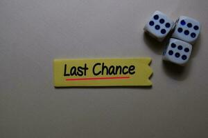 Last Chance write on a sticky note isolated on office desk. photo