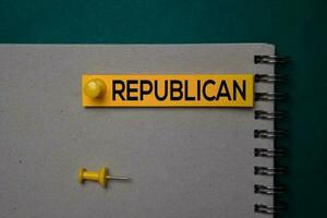 Republican write on a sticky note isolated on green background. photo