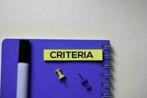 Criteria text on sticky notes isolated on office desk photo