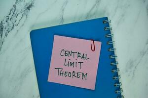 Central Limit Theorem write on sticky note isolated on Wooden Table. photo