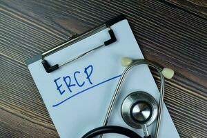 ERCP write on a paperwork isolated on Wooden Table. photo