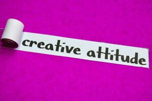 Creative Attitude text, Inspiration, Motivation and business concept on purple torn paper photo