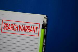 Search Warrant write on a book isolated on blue background. photo