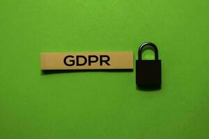 GDPR write on sticky notes and padlock. Isolated on green table background photo