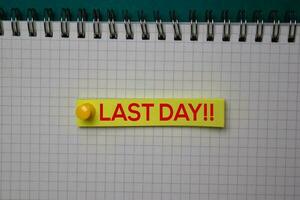 Last Day write on a sticky note isolated on green background. photo