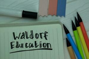 Waldorf Education write on a book isolated on office desk. photo