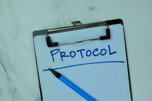 Concept of Protocol write on a paperwork isolated on Wooden Table. photo