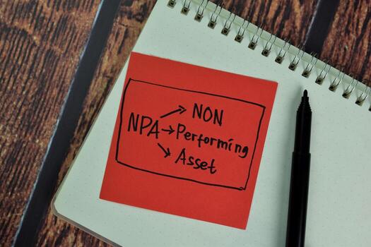 NPA - Non Performing Asset write on sticky notes isolated on Wooden Table. photo