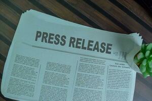 Press Release text in headline isolated on office desk. Newspaper concept photo