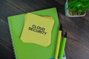 Cloud Security write on sticky notes isolated on Wooden Table. photo
