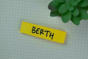 Berth write on sticky notes isolated on Wooden Table. photo