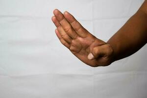 Close up Asian man shows hand gestures it means Let's Go isolated on white background photo