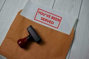 Red Handle Rubber Stamper and You've Been Served text isolated on the table. photo