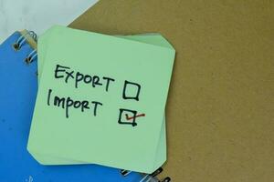 Concept of Export or Import He choose Import write on sticky notes isolated on Wooden Table. photo