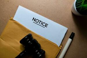 Notice in brown envelope and judges gavel. Justice and Law Concept photo