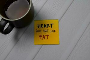 Heart Does Not Like Fat write on sticky note isolated on wooden table. photo