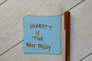 Honesty Is The Best Policy write on sticky notes isolated on Wooden Table. photo
