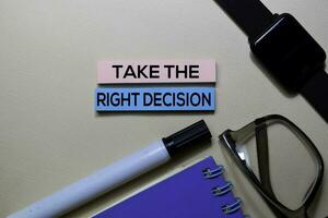 Take The Right Decision text on sticky notes isolated on office desk photo