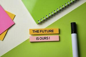 The Future is Ours text on top view office desk table of Business workplace and business objects. photo