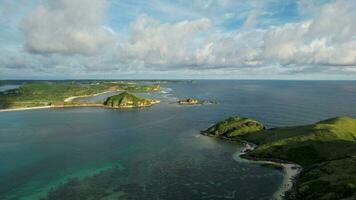 Aerial view of Tanjung Aan, Tropical island with sandy beach and turquoise ocean with waves. Lombok. Indonesia, Mach 22, 2022 photo