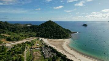 Aerial view of Selong Belanak, Tropical island with sandy beach and turquoise ocean with waves. Lombok. Indonesia, Mach 22, 2022 photo