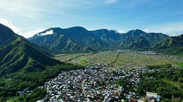 Aerial view of some agricultural fields in Sembalun. Sembalun is situated on the slope of mount Rinjani and is surrounded by beautiful green mountains. Lombok, Indonesia, March 22, 2022 photo