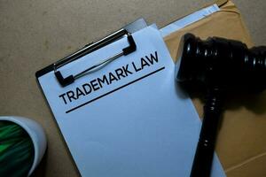 Trademark Law above brown envelope and judges gavel. Justice and Law Concept photo