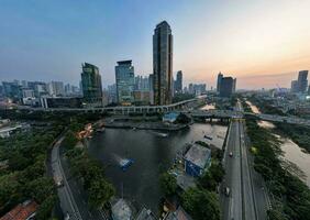 Aerial view of office buildings in Jakarta central business district and noise cloud when sunset. Jakarta, Indonesia, August 1, 2022 photo