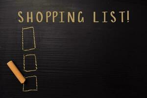 Shopping List written with color chalk. Supported by an additional services. Blackboard concept photo