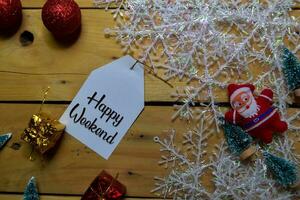 Happy Weekend write on label with wooden backgroud. Frame of Christmas Decoration. photo