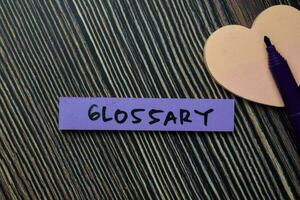 Glossary write on sticky notes isolated on office desk. photo