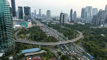 Aerial view of the city traffics at semanggi Roundabout, Jakarta, Indonesia. Aerial view on highways and skyscrapers with noise cloud. Jakarta, Indonesia, December 21, 2022 photo