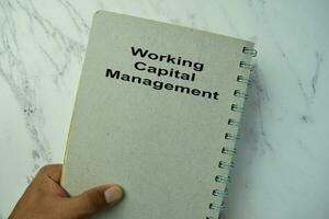 Working Capital Management write on a book isolated on office desk. photo