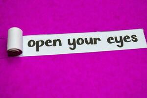 Open Your Eyes text, Inspiration, Motivation and business concept on purple torn paper photo