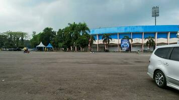 view of the Beautiful scenery of Kanjuruhan Stadium. with Malang cityscape background. Malang, Indonesia, August 26, 2022 photo