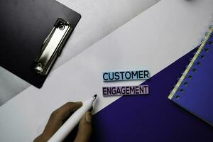 Customer Engagement text on sticky notes with color office desk concept photo