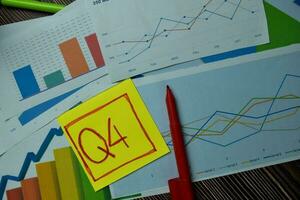 Q4 4th Quarter Period write on sticky notes isolated on Office Desk. Stock market concept photo