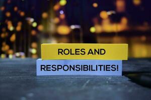 Roles and Responsibilities on the sticky notes with bokeh background photo