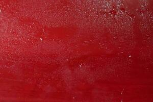 Water drops close up. Abstract red background of waterdrops, droplets. photo