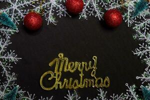 merry christmas text and Decorative Christmas isolated on black background photo