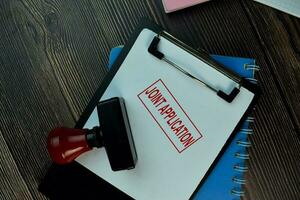 Red Handle Rubber Stamper and Joint Application text isolated on the table. photo