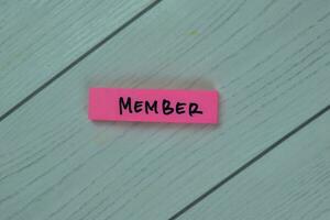 Concept of Member write on sticky notes isolated on Wooden Table. photo