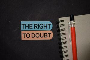 The Right To Doubt write on sticky note isolated on Office Desk photo