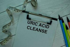 Uric Acid Cleanse write on a paperwork isolated on office desk. photo