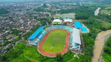 Aerial top down view of the Beautiful scenery of Moch. Soebroto Stadium. with Magelang cityscape background. Magelang, Indonesia, December 6, 2021 photo