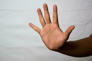 Close up Asian man shows hand gestures it means Hold Off isolated on white background photo